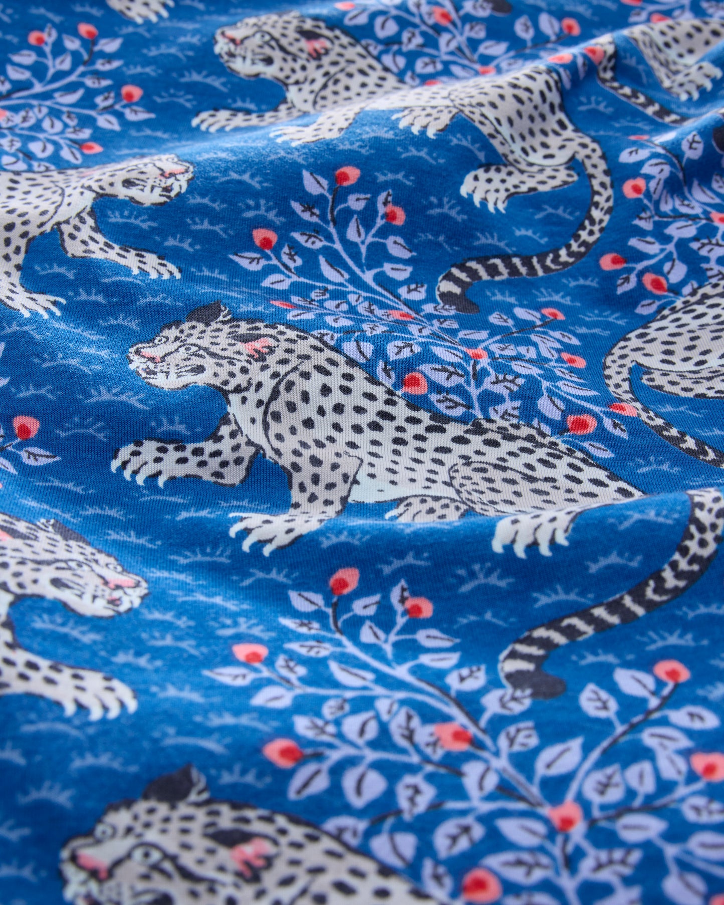 Close-up of the indigo Bagheera print with spotted cats and leafy branches