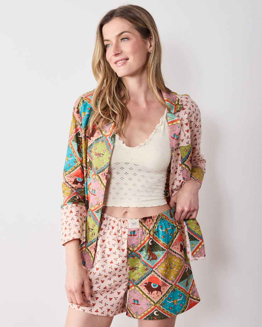 Model wearing the coordinated patterned long-sleeve shirt and boxer shorts over a white sleeveless top.