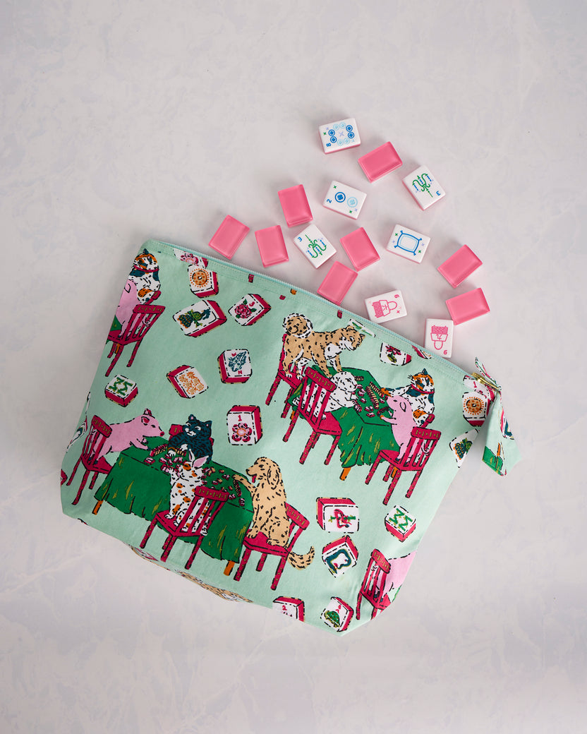 Pale jade Mah Jongg Menagerie zip pouch displayed with scattered Mah Jongg tiles