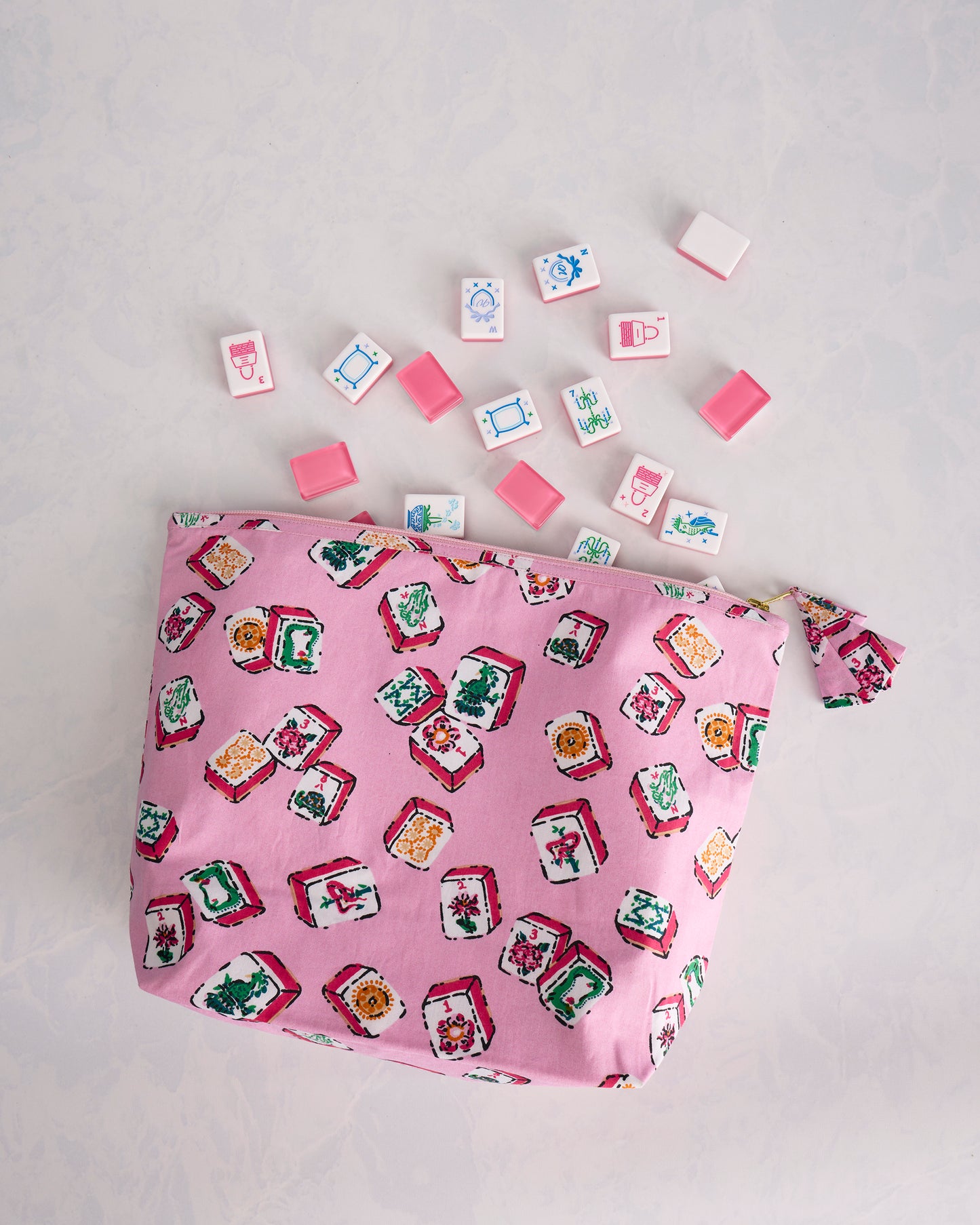 Peony pink Lucky Tiles zip pouch displayed with scattered Mah Jongg tiles