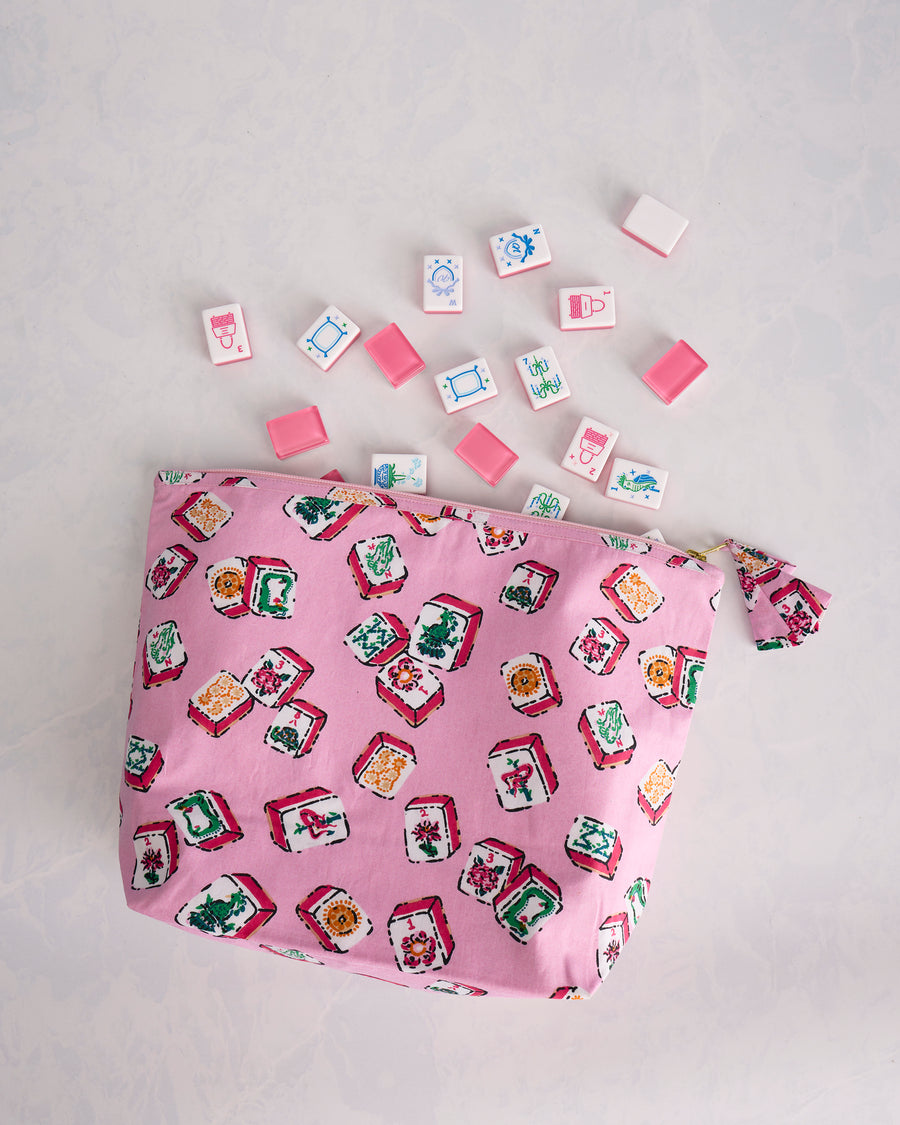 Peony pink Lucky Tiles zip pouch displayed with scattered Mah Jongg tiles