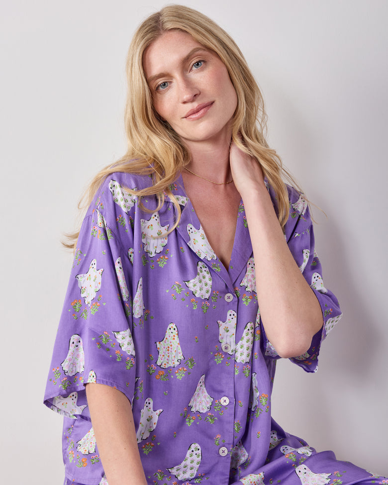 Close-up of the purple Gardening Ghosts pajama top with a collared neckline, front buttons, and white ghost-and-floral print.