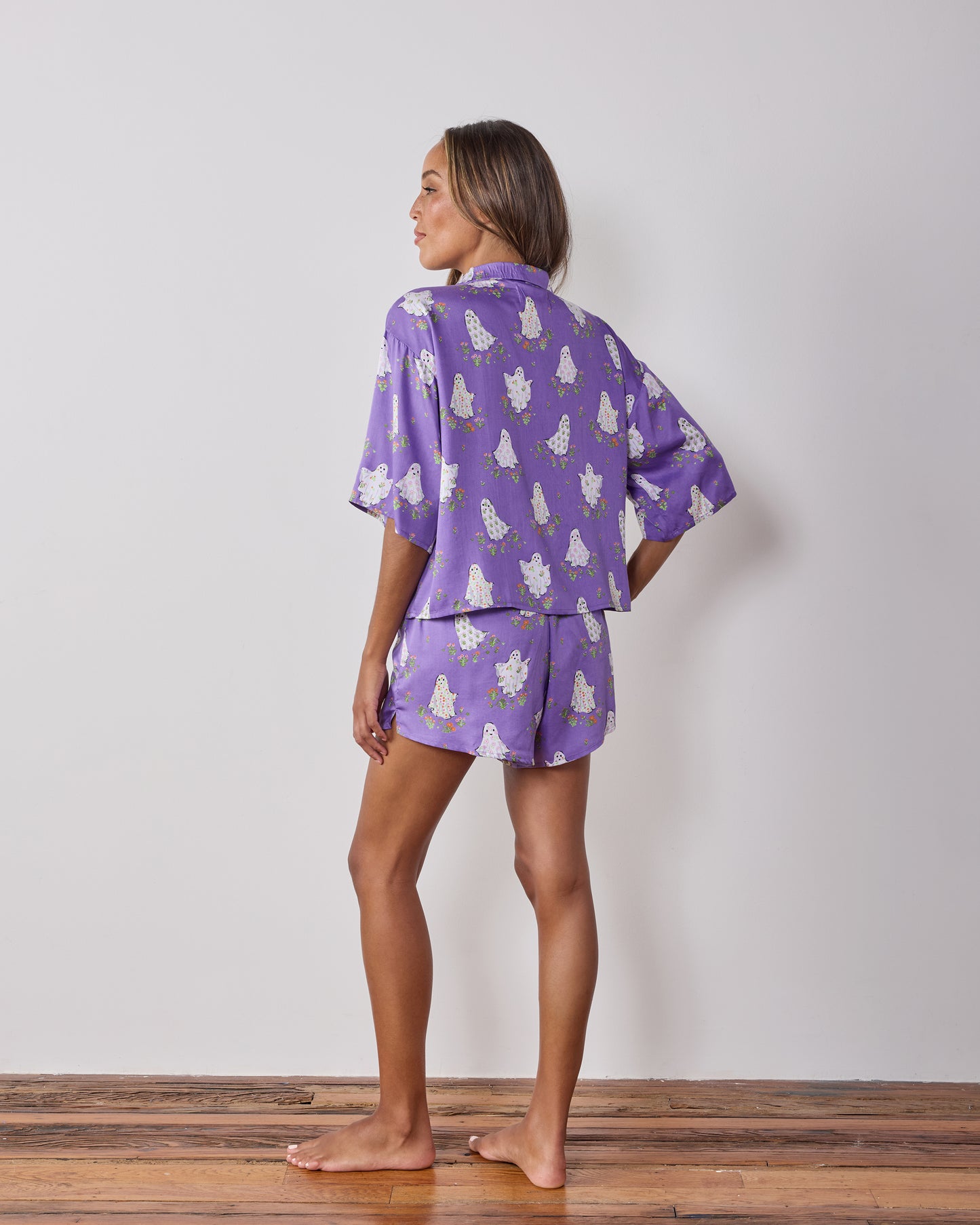 Back view of the Eerie Amethyst Gardening Ghosts short pajama set, showing the matching top and shorts with ghost-and-flower print.