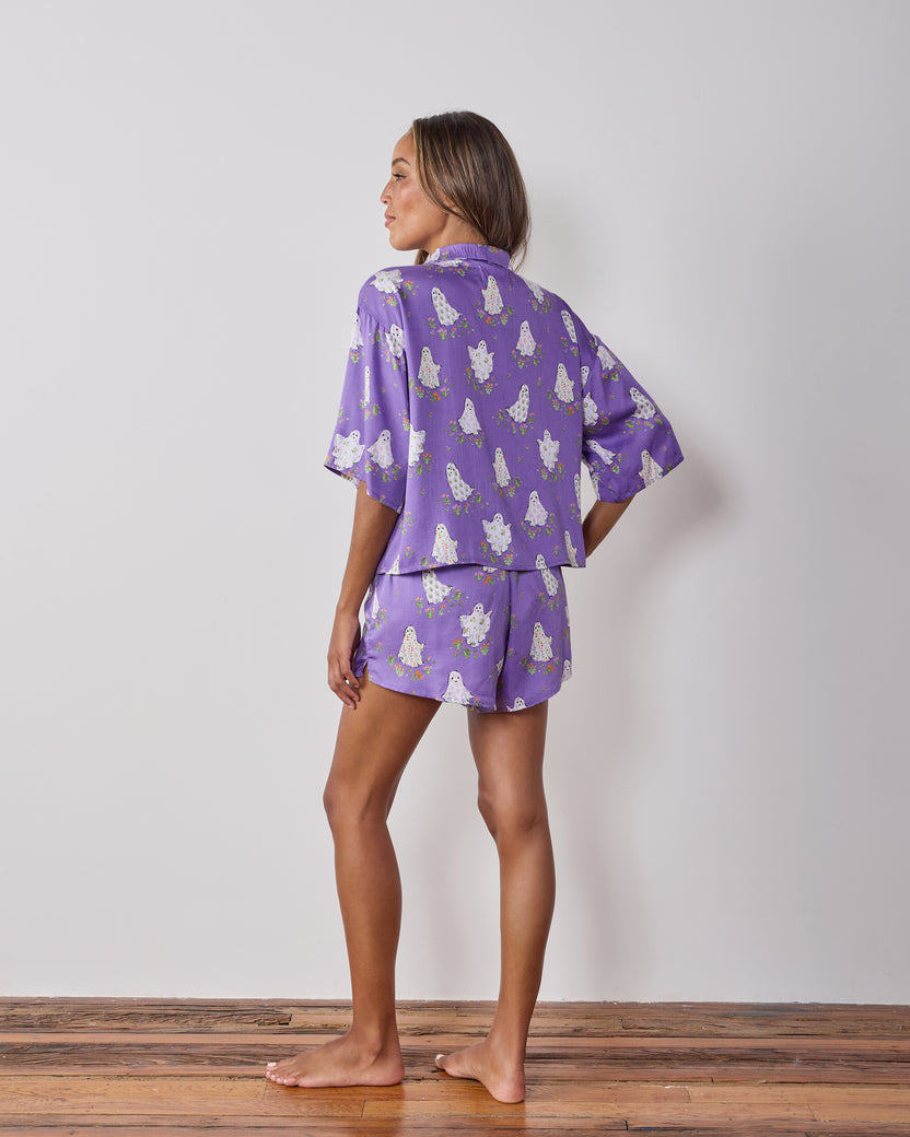 Back view of the Eerie Amethyst Gardening Ghosts short pajama set, showing the matching top and shorts with ghost-and-flower print.