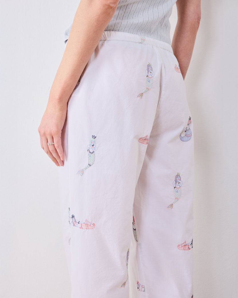 Close rear view of the tall pajama pants showing the waistband and mermaid motifs.