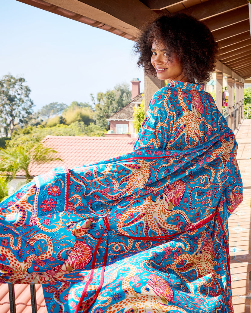 Back view of the Octopus Isle pajama set with a matching printed robe spread across a balcony