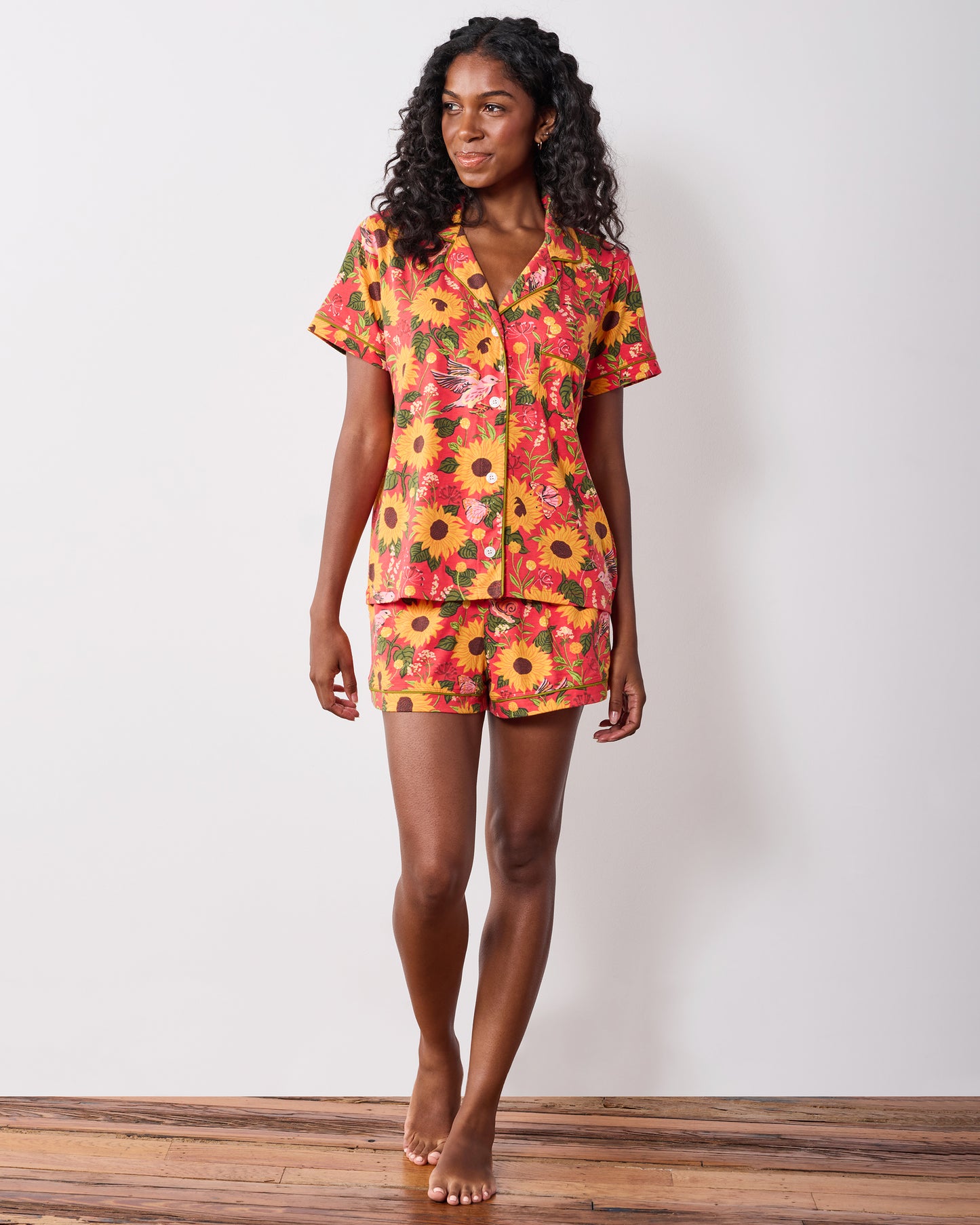 Model wearing the orange Autumn Sunflowers short pajama set, shown full length.
