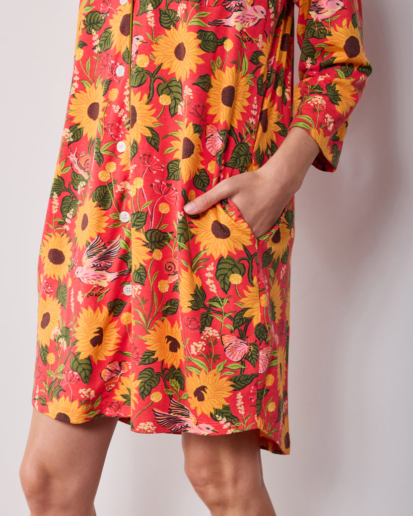 Close-up of the orange Autumn Sunflowers sleep shirt showing the lower buttons, side pocket, and hem.
