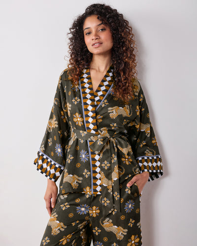 Front view of the olive Wrap Set with a belted wrap top, patterned trim, and matching pants featuring leopard and flower prints.
