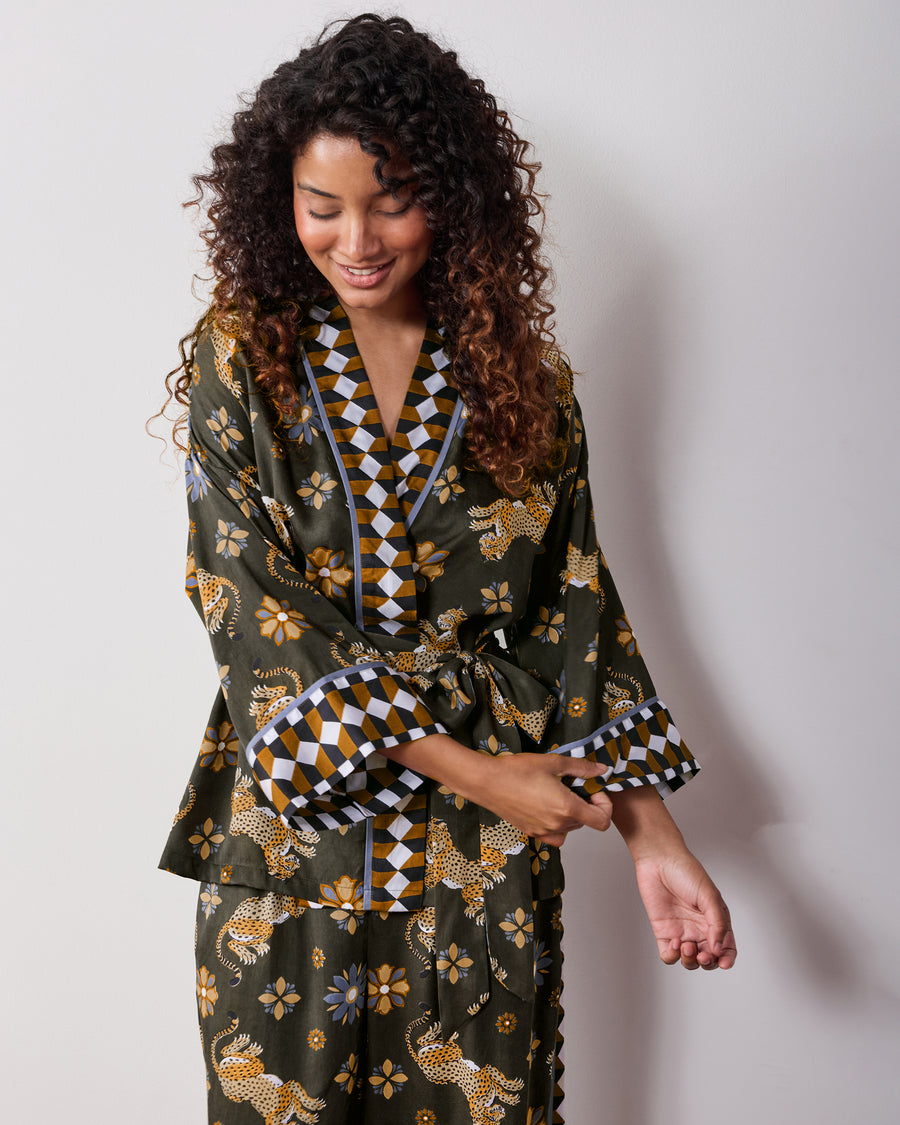 Angled front view of the olive Wrap Set with a belted wrap top, geometric trim on the neckline and cuffs, and matching printed pants.