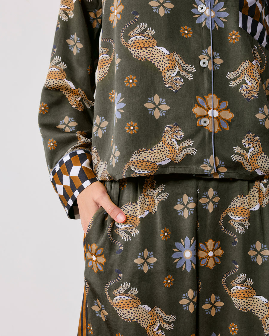 Close-up front view of the Rittenhouse set showing the button-front printed top, geometric-print cuff, and matching pants with a side pocket.