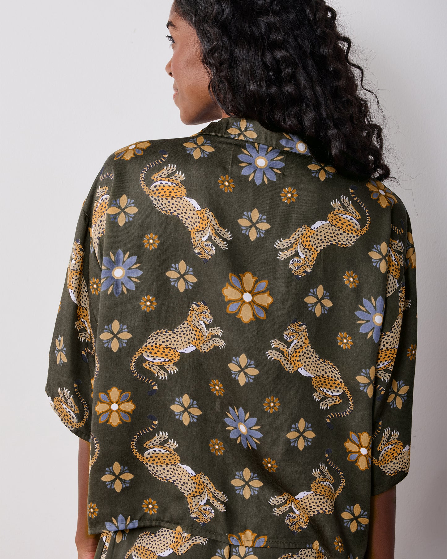 Close-up back view of the olive Wildest Dreams pajama shirt, highlighting the leopard and flower print.