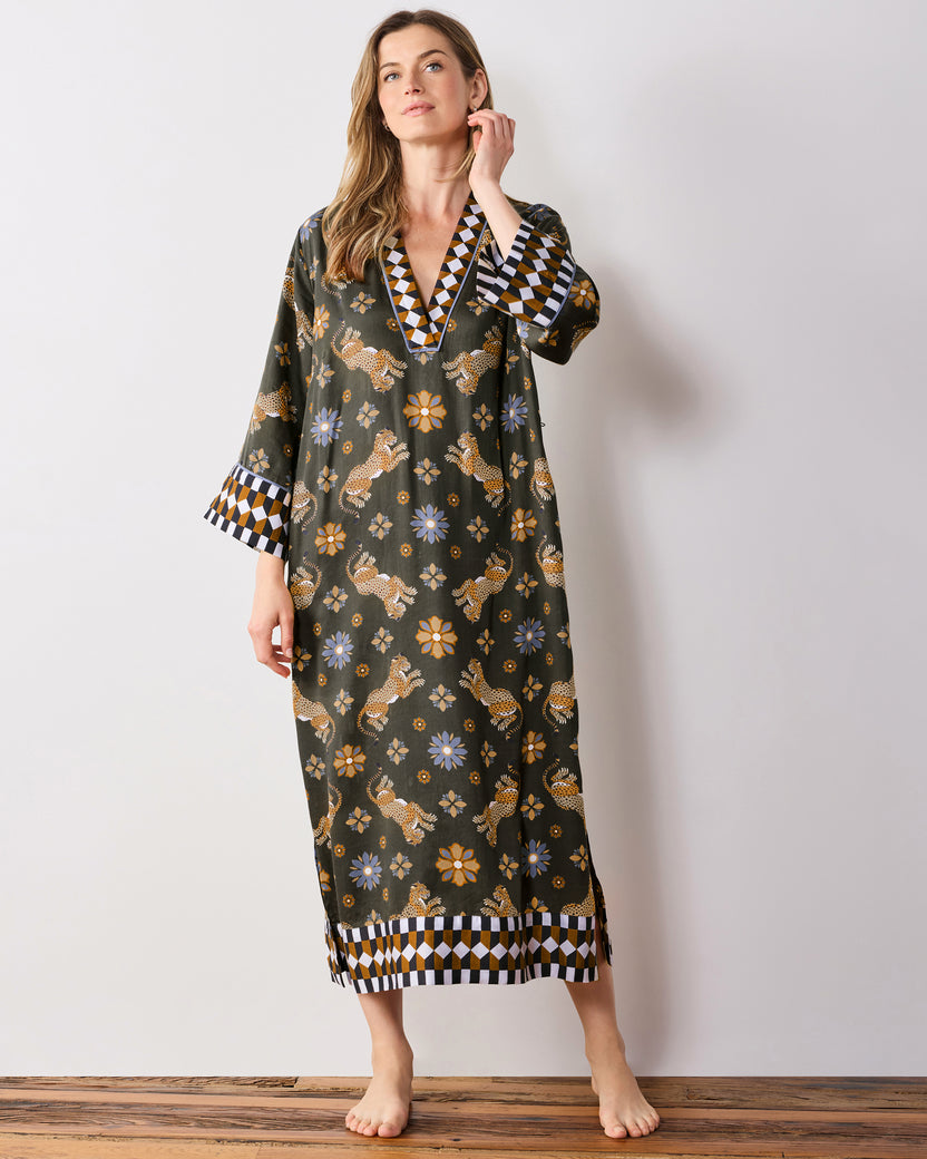 Full-length front view of the olive Bagheera Kaleidoscope Kennedy caftan, showing the geometric-trimmed V-neck, wide cuffs, and hem border.