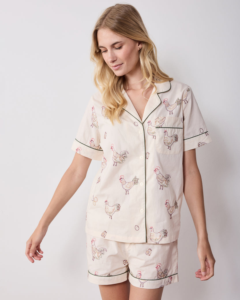 Front view of the short pajama set with a short-sleeve button-front top, chest pocket, and matching shorts with embroidered hens.