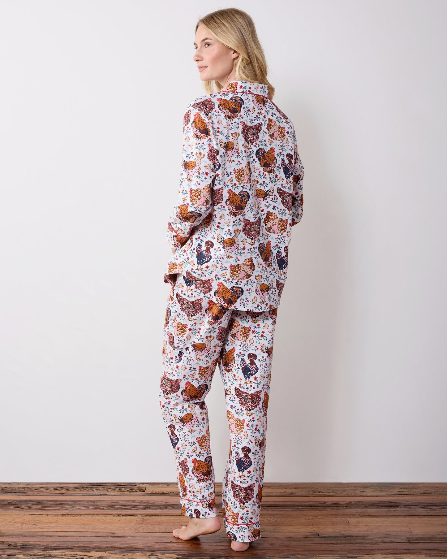 Back view of a long chicken-print pajama set with a collared top and long pants.