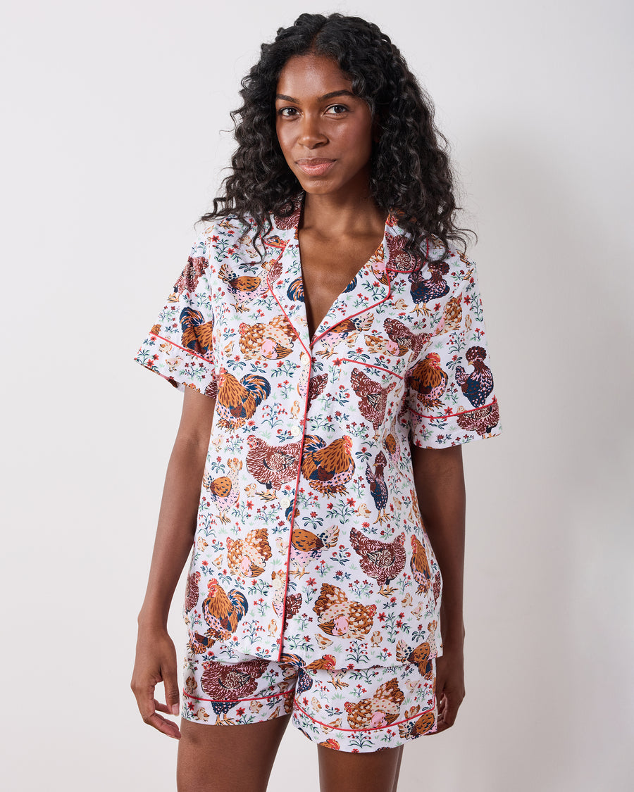 Front view of a chicken-print short pajama set with a collared button-front top and shorts.