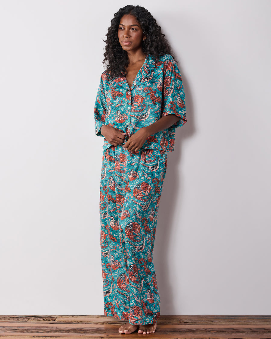 Three-quarter front view of the teal patterned button-front pajama set with wide-leg pants.