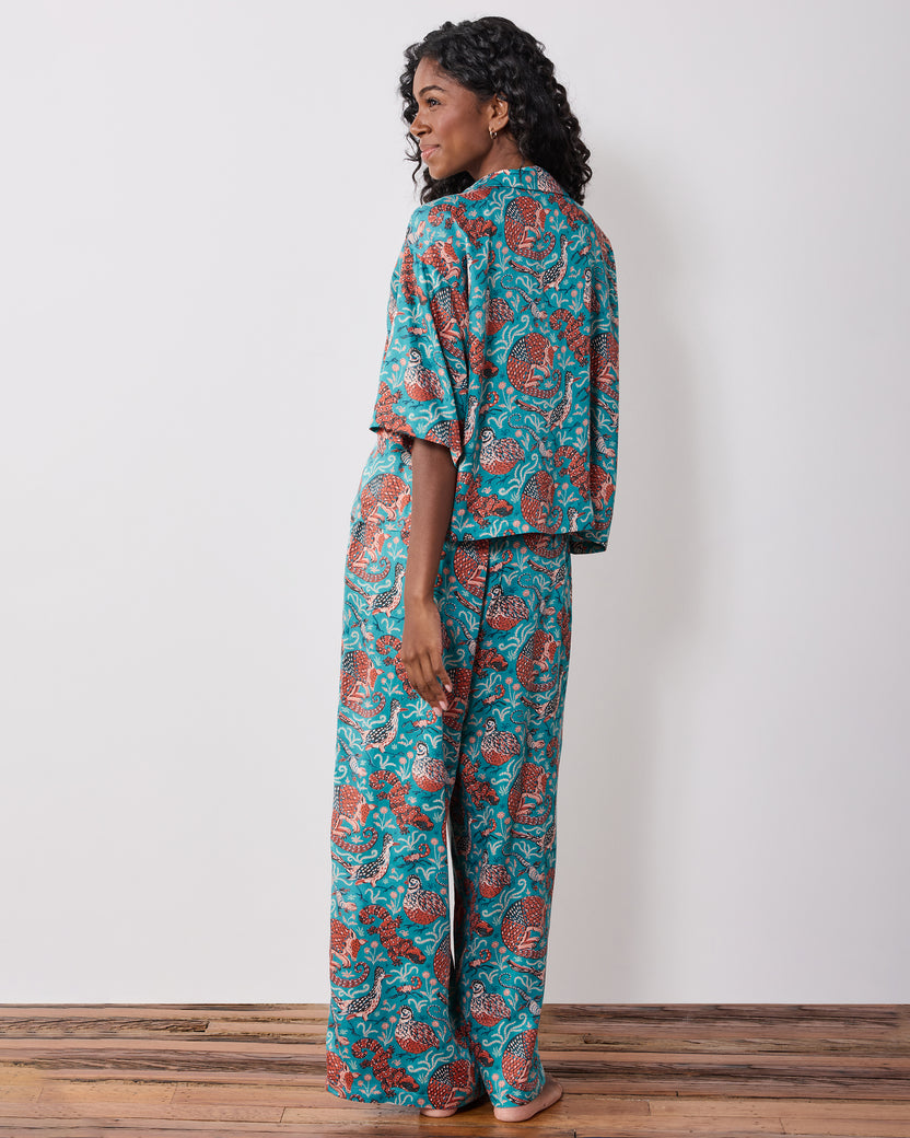 Back view of the teal patterned pajama set with a short-sleeve top and wide-leg pants.