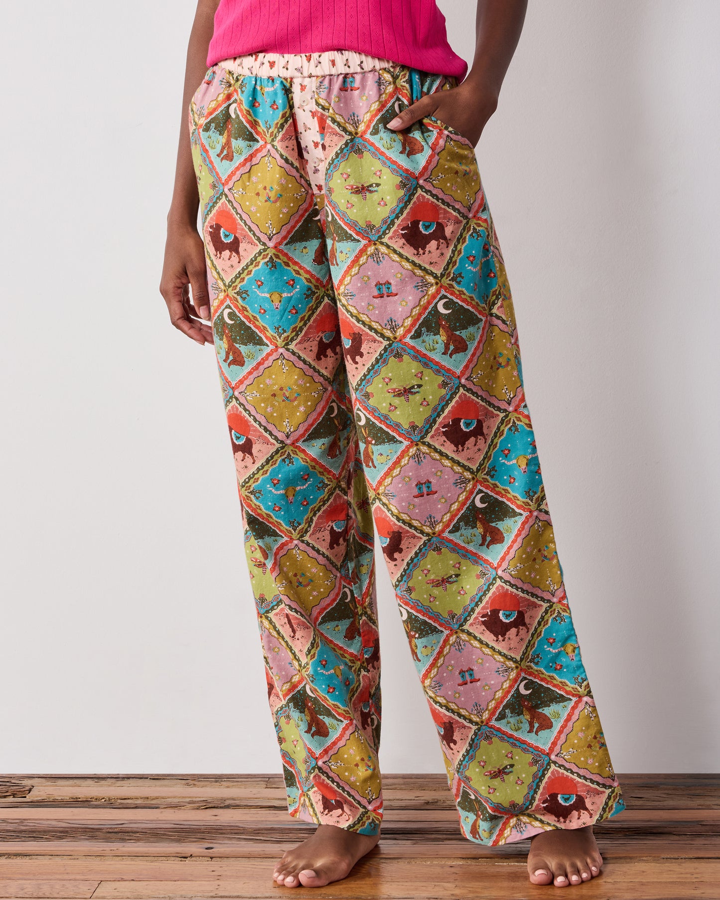 Front close-up of the Western Scenes wide-leg pajama pants, showing the relaxed legs, elastic waistband, and colorful diamond-patterned print.