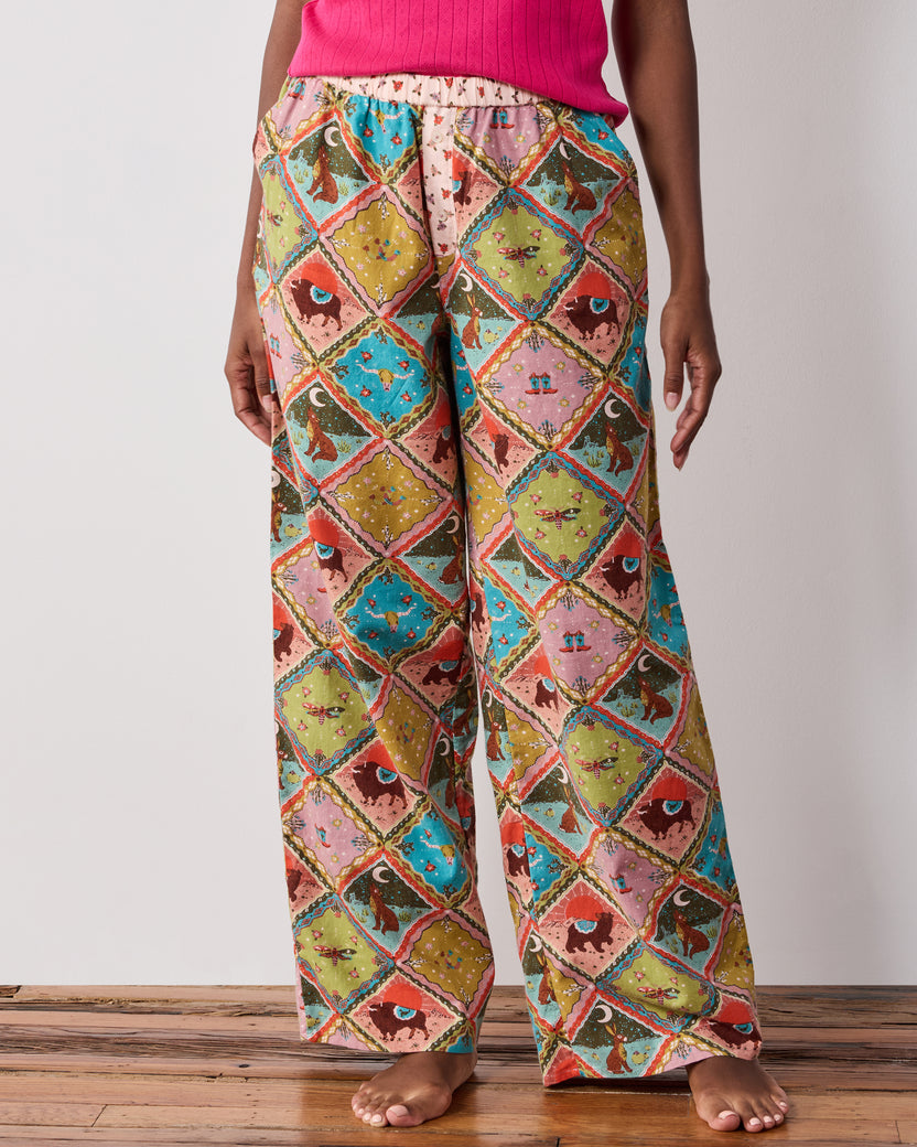 Front close-up of the Western Scenes wide-leg pajama pants, showing the elasticized waistband and patchwork print.