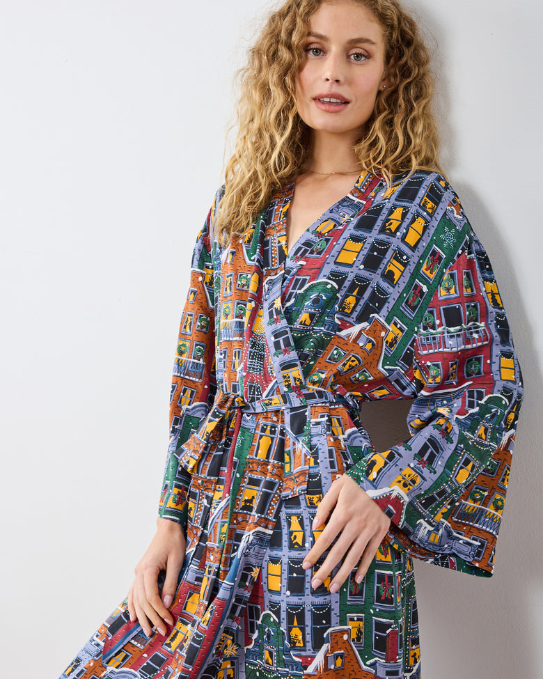 Waist-up view of belted robe with a multicolored brownstone-building print