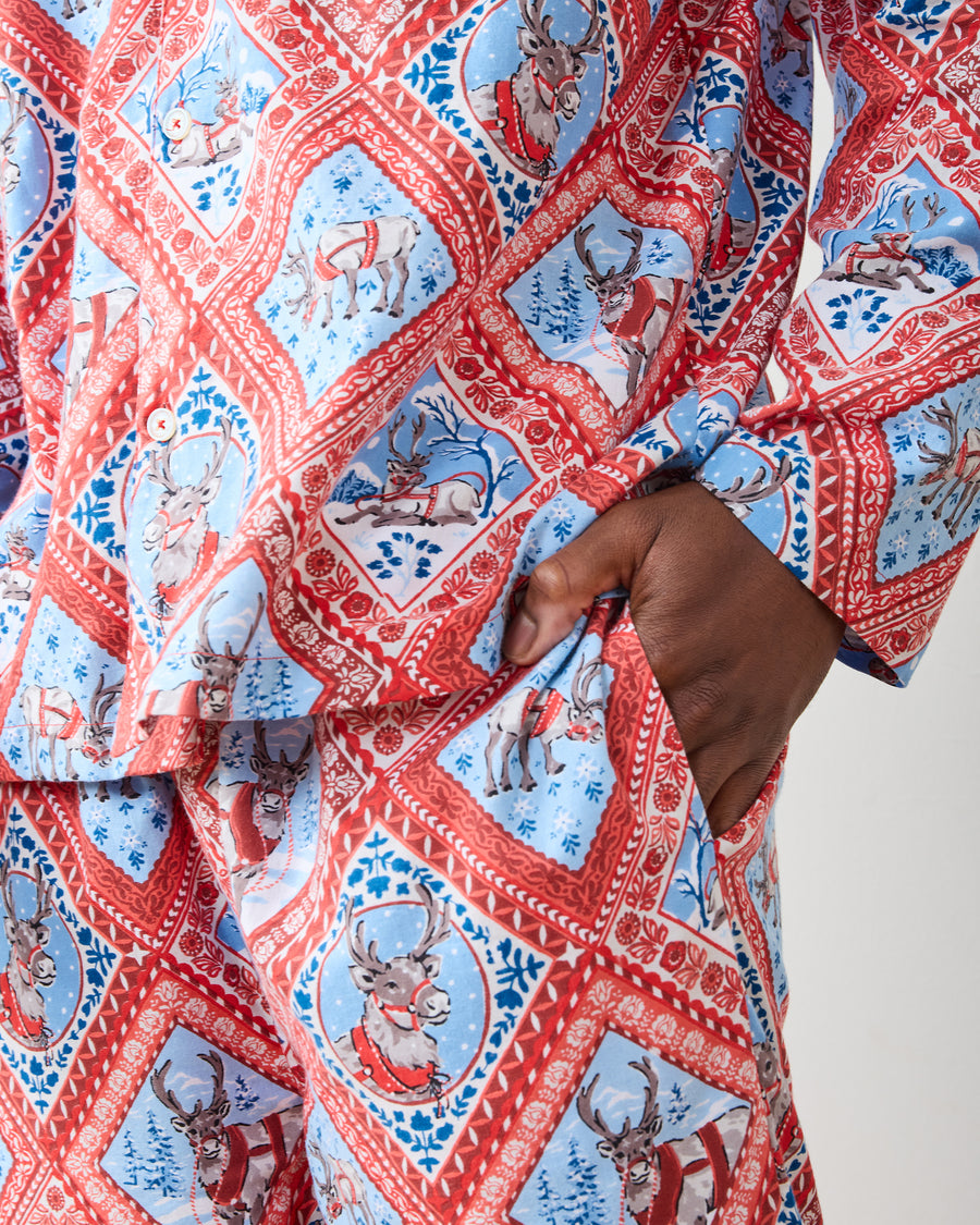 Close-up of Reindeer Games pajama set showing framed reindeer print, white buttons, and pants pocket