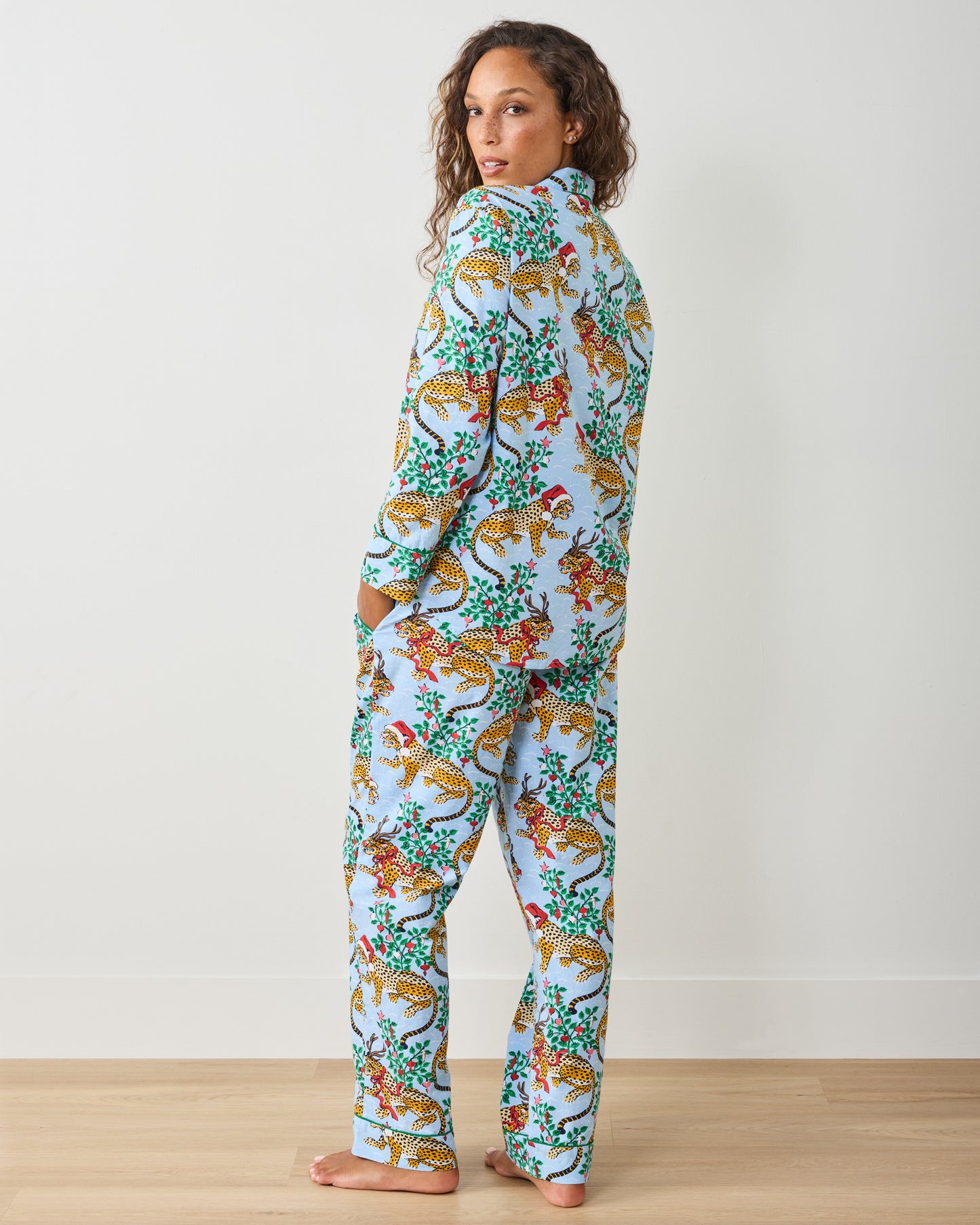 Rear three-quarter view of the pale blue long pajama set with holiday leopard print
