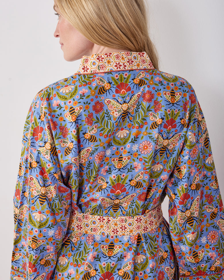 Back view of the Delphinium Blue Bee Tapestry robe showing its floral and bee print, collar, belt, and sleeve trim.