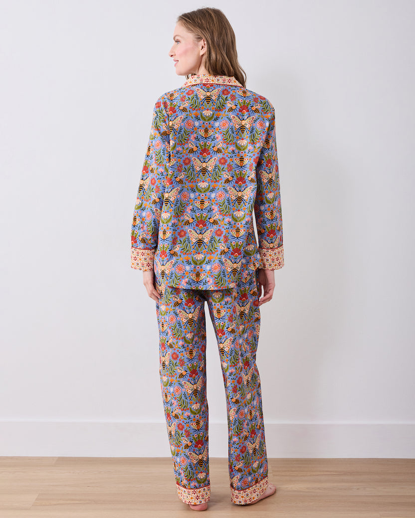 Back view of the Bee Tapestry Delphinium Blue long pajama set, showing the full-length button-down top and matching pants with contrasting cuffs and hem.
