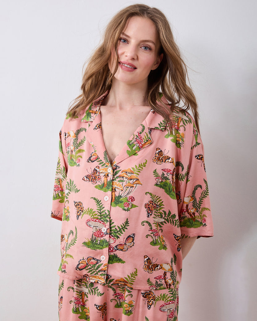 Front view of the pink Butterfly Forager tall satin Wildest Dreams pajama set with a button-front short-sleeved top and wide-leg pants.