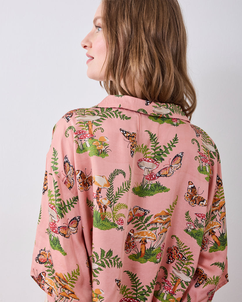 Back view of the pink Butterfly Forager petite satin Wildest Dreams pajama top showing its collar and butterfly, mushroom, and fern print.