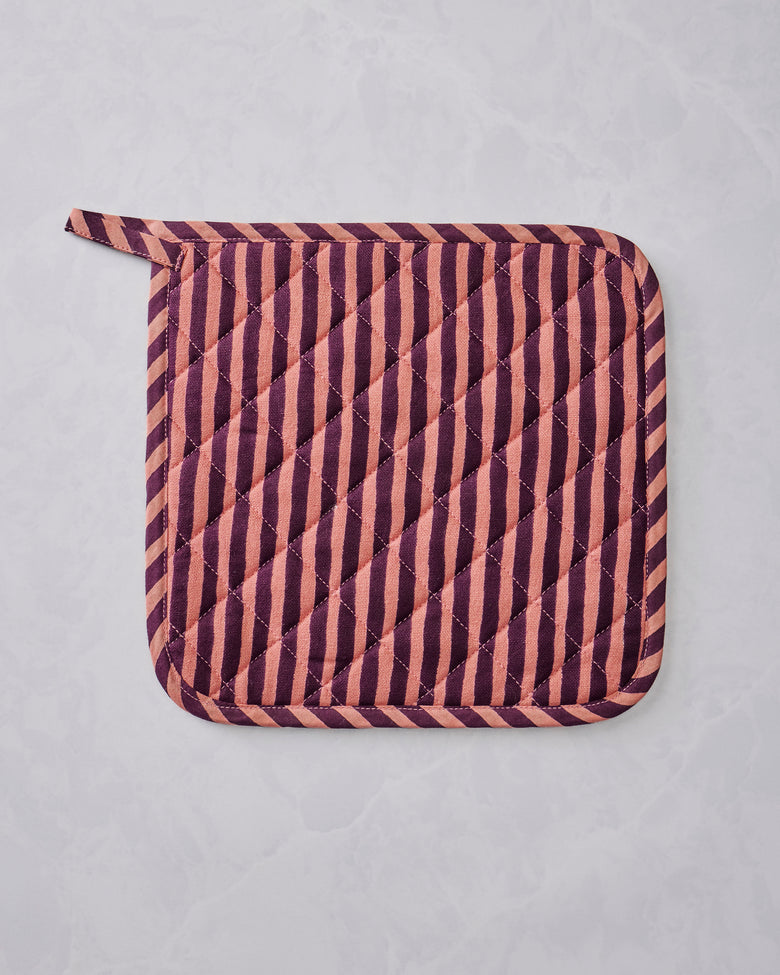 Quilted Champagne & Caviar pot holder with diagonal burgundy and peach stripes and rounded corners, shown flat.