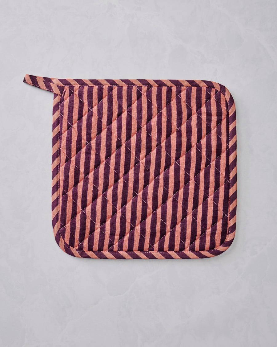 Quilted Champagne & Caviar pot holder with diagonal burgundy and peach stripes and rounded corners, shown flat.
