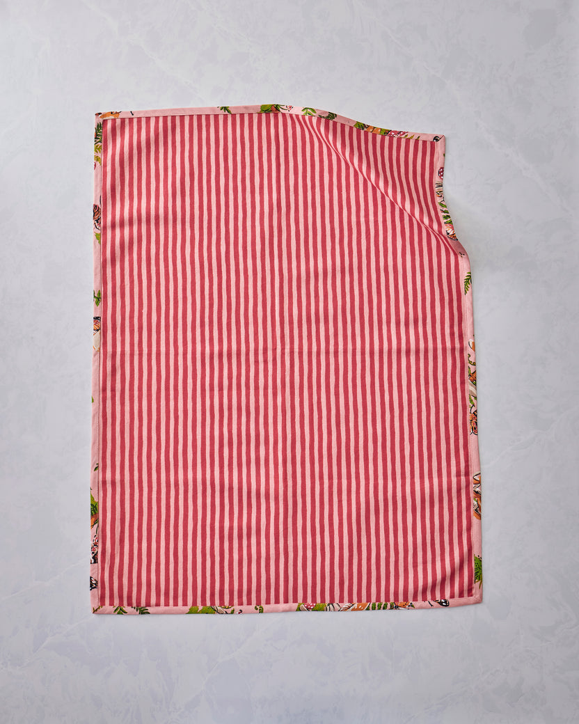 Back view of a Butterfly Forager tea towel showing a pink-and-red vertical stripe design, with the printed pattern visible along the edges.