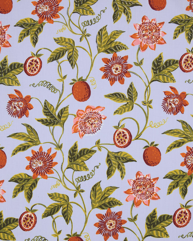 Passion Vine print with orange fruit, cut fruit, flowers, green leaves, and curling vines on a pale blue background