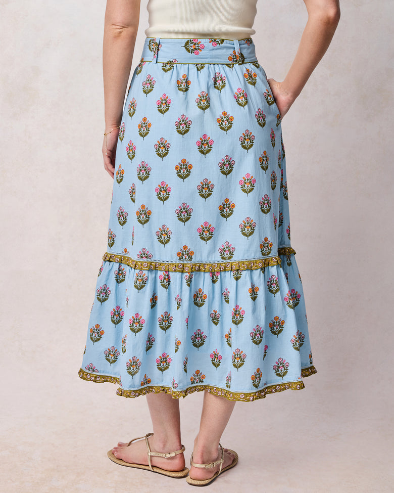 Back view of soft blue floral Emmie skirt with a wide waistband and gathered lower tier