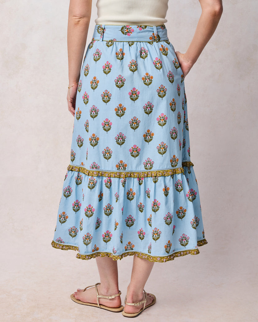 Back view of soft blue floral Emmie skirt with a wide waistband and gathered lower tier