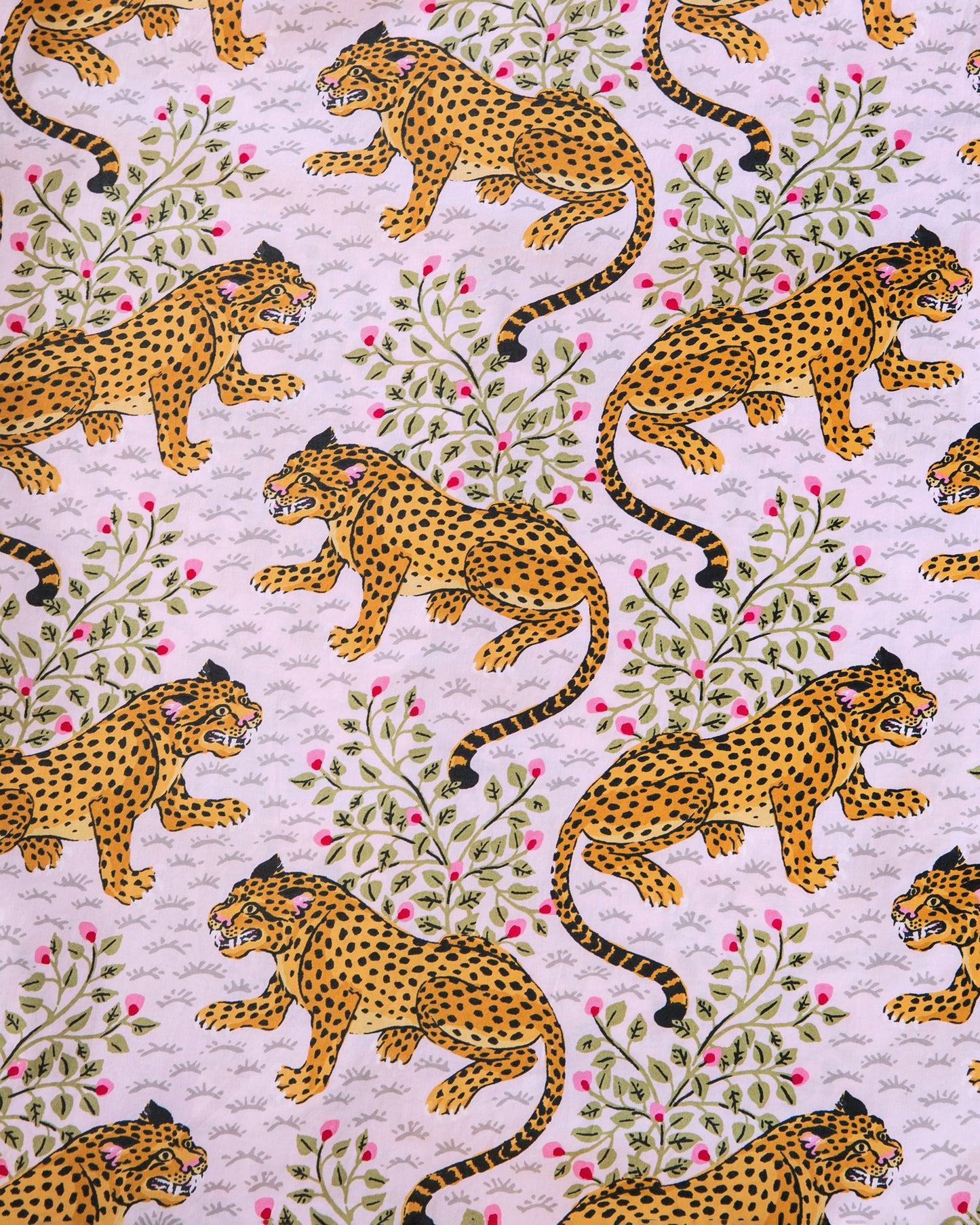 Close-up of the blush print with orange spotted cats, leafy branches, and pink buds.