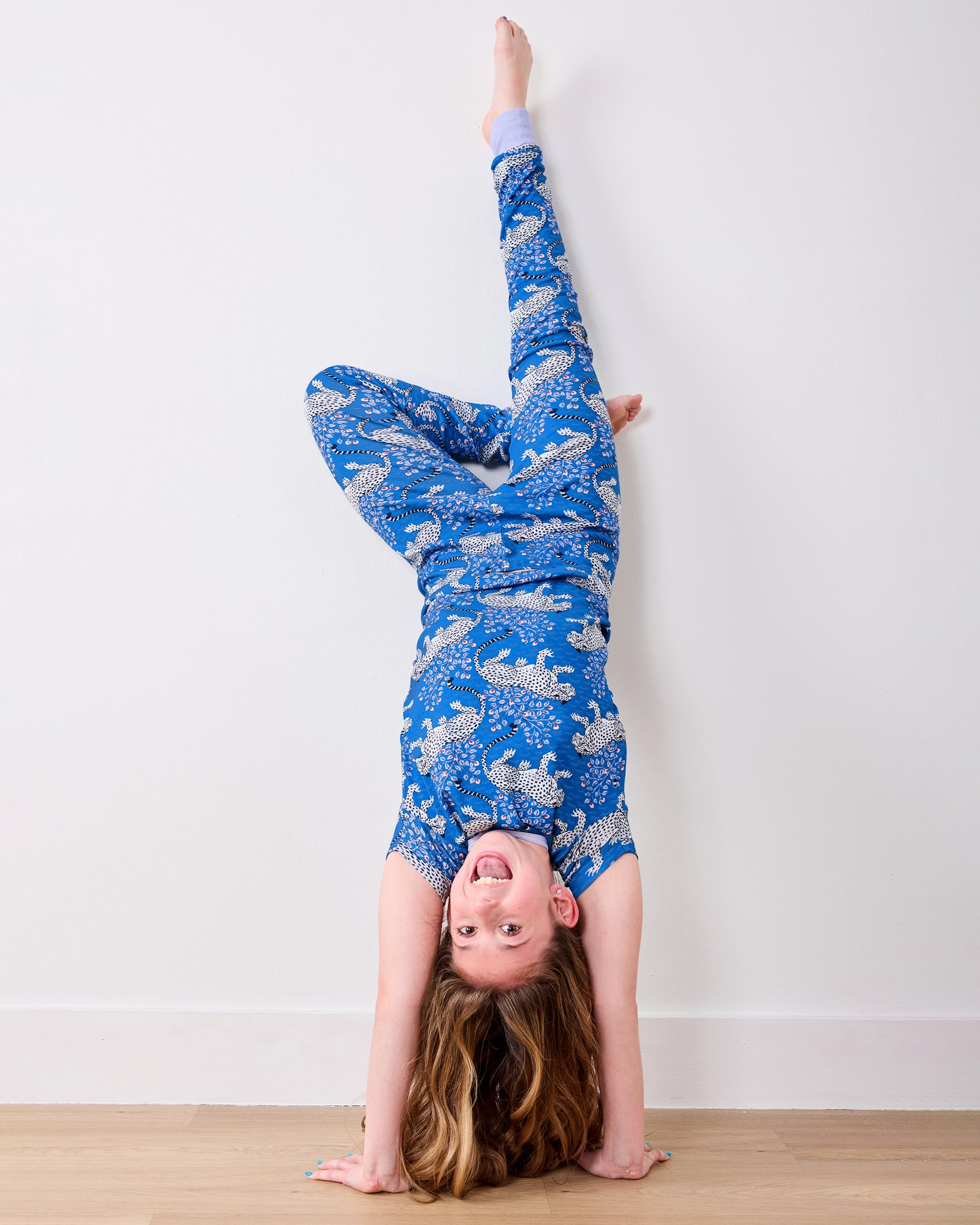 Model doing a handstand in the indigo Bagheera short-sleeve pajama set