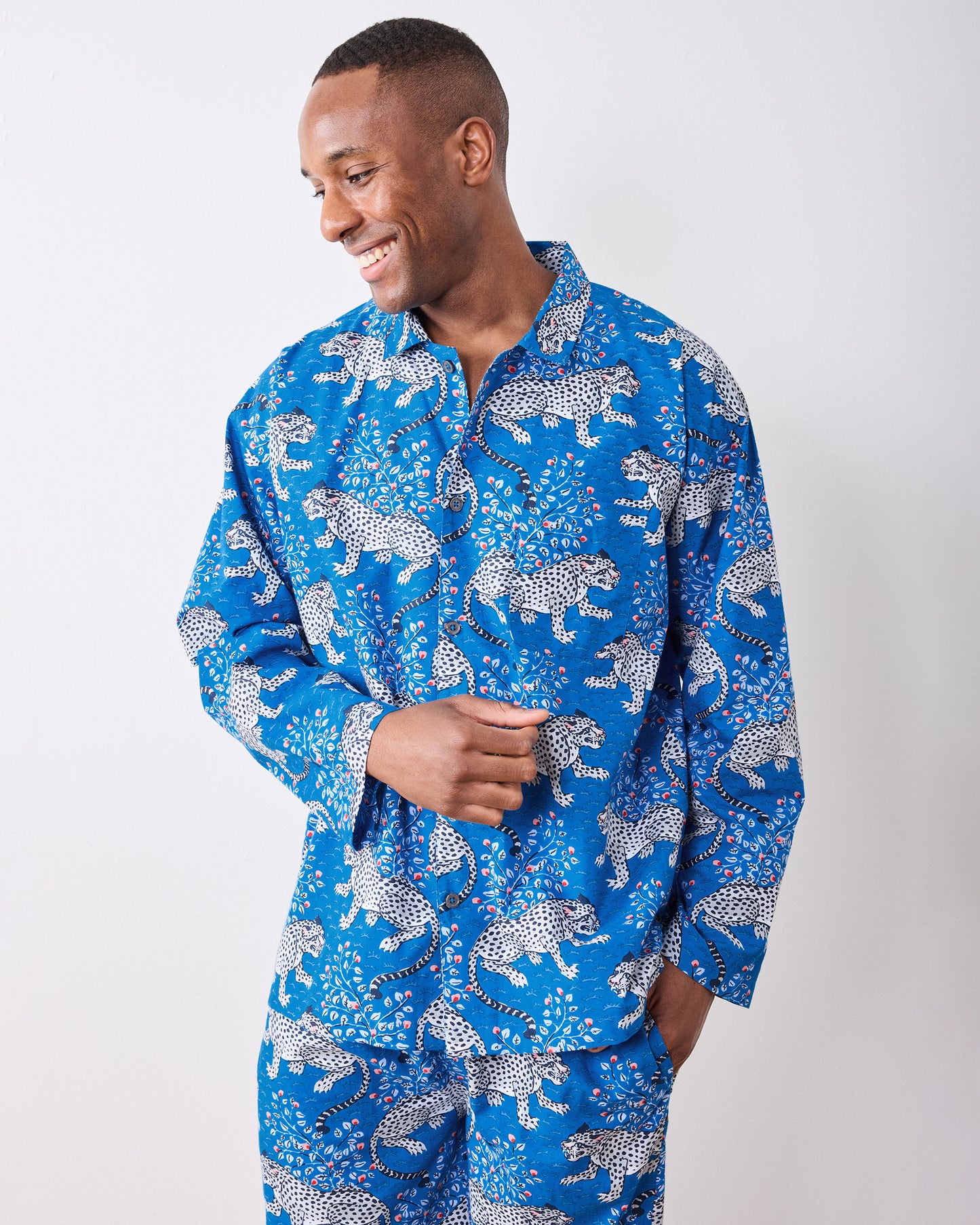 Three-quarter front view of the indigo long pajama set with one hand in a pants pocket