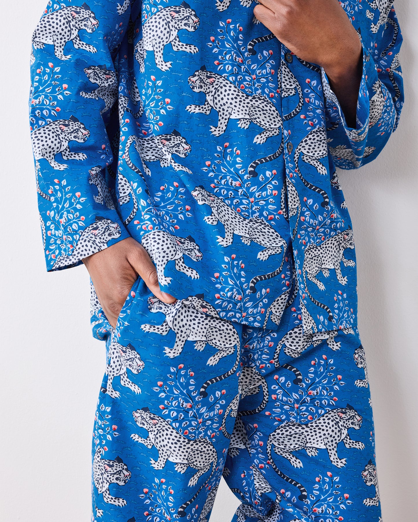Close-up of the indigo pajama set showing the leopard print, buttons, cuff, and pants pocket