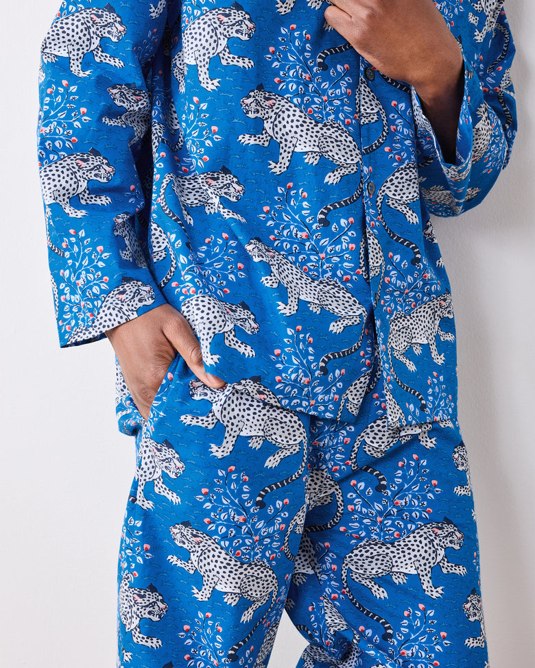 Close-up of the indigo pajama set showing the leopard print, buttons, cuff, and pants pocket