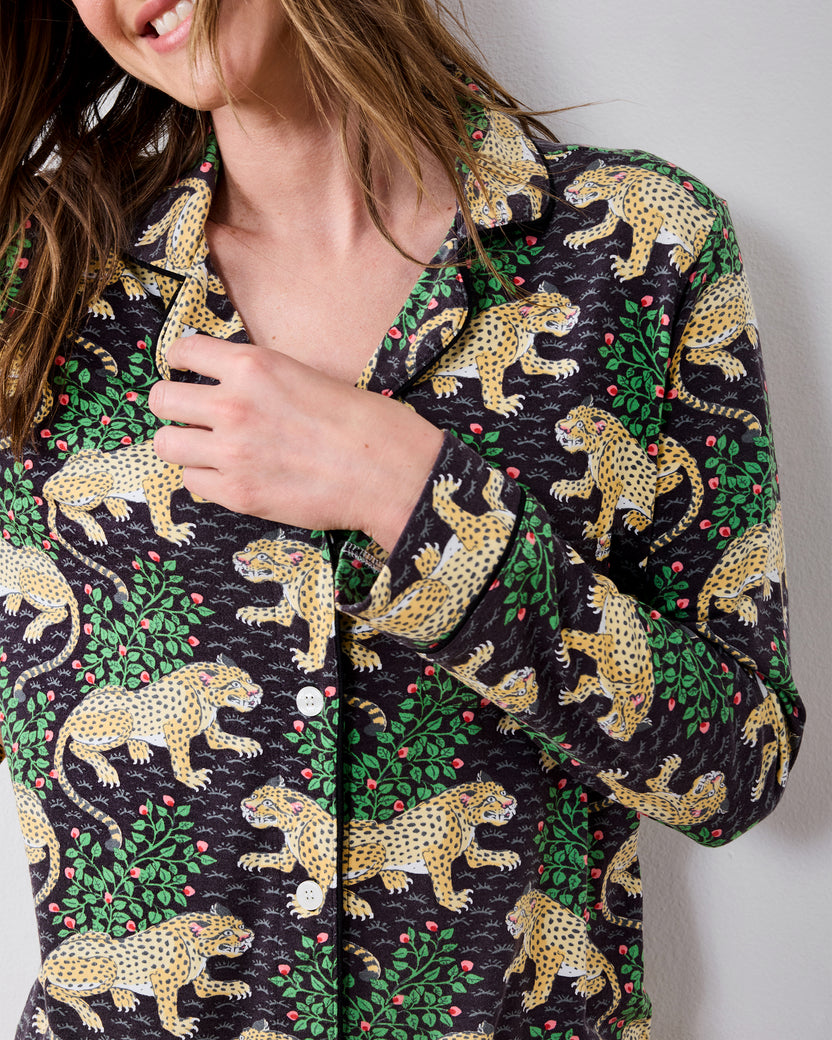 Close-up of the Bagheera long pajama shirt showing its collar, white buttons, long sleeve, and leopard-and-greenery print.