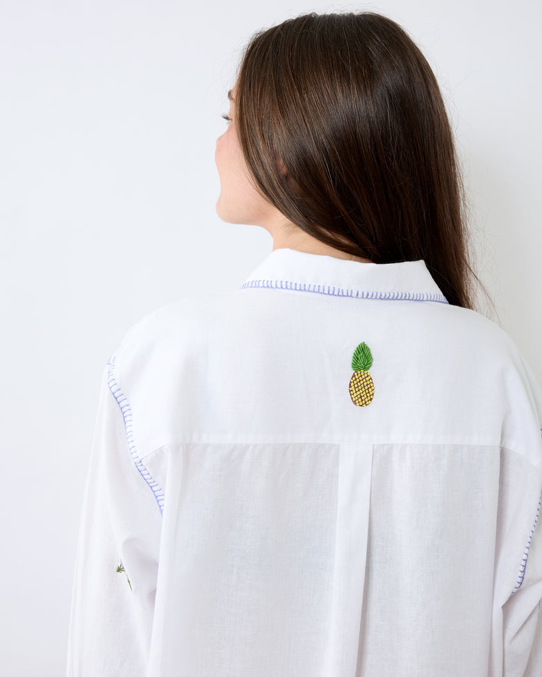 Back view close-up of the white button-down shirt showing the collar, back yoke, and pineapple embroidery.