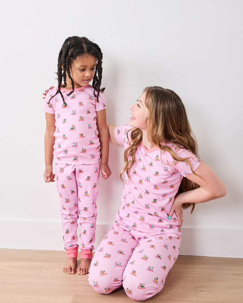 Two children modeling matching pink Flamingo Floaties short-sleeve pajama sets