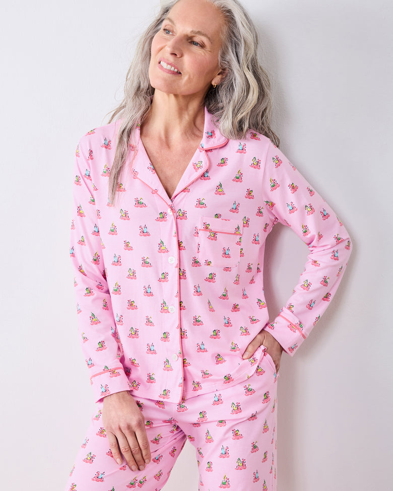 Front three-quarter view of a model wearing the pink Flamingo Floaties button-down long pajama set