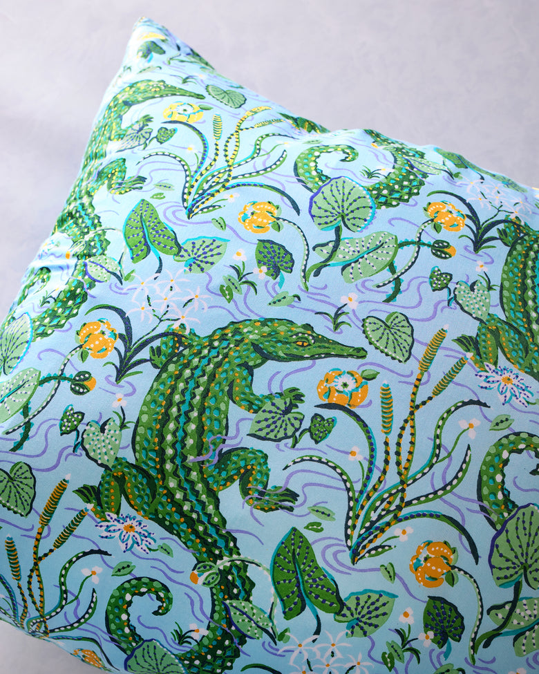 Close-up of the pillowcase's alligator, foliage, and floral print