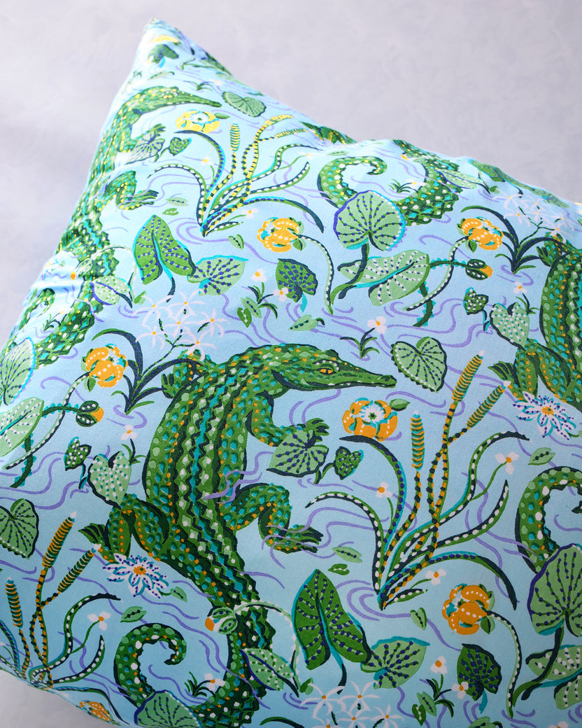 Close-up of the pillowcase's alligator, foliage, and floral print