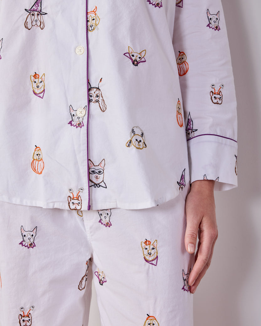 Close-up of the Cloud Halloween Hounds pajama top and pants, showing the button placket, piped cuff, and dog-face costume print.