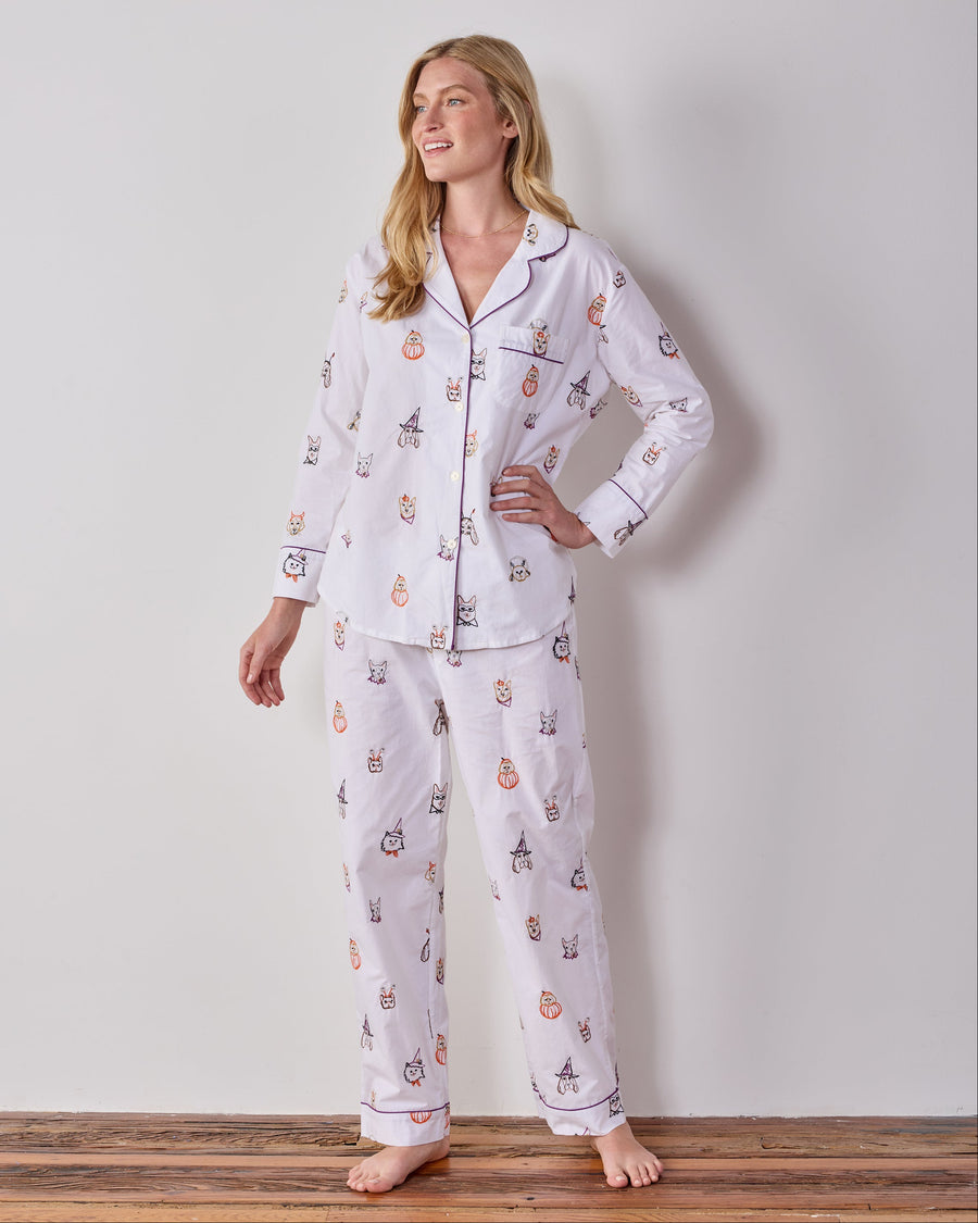 Full-length front view of the Cloud Halloween Hounds petite long pajama set, with a button-front top and matching pants covered in dog faces wearing costumes.